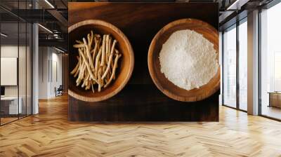 Organic ashwagandha powder in a wooden bowl with fresh roots and green leaves on a rustic wooden background. Also known as Indian Ginseng or Indian Winter cherry.  Wall mural