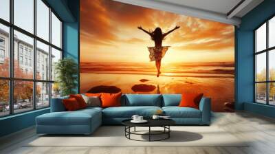 Silhouette of happy joyful woman jumping and having fun at the beach against the sunset. Freedom and leisure vacation concept. Wall mural