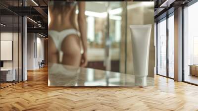 White cosmetic tube on table in bathroom background with blurred woman Wall mural