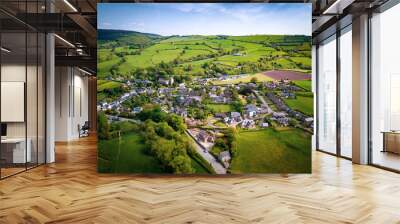 Aerial view above houses in an old British village in the countryside. Warm colours give a homely effect. Wall mural