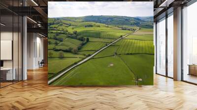 aerial view looking down on a rural road in the uk countryside. on a bright sunny day, farmland and  Wall mural