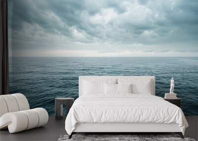 a large body of water under a cloudy sky Wall mural