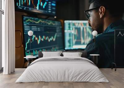 a man sitting in front of two computer monitors Wall mural