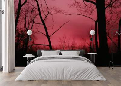 a red sky with some trees in the foreground Wall mural