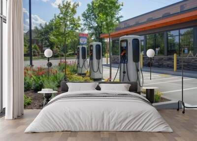 a row of electric cars parked in front of a building Wall mural