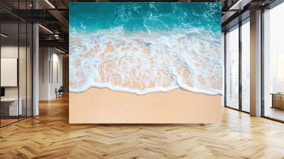 a sandy beach with a wave coming in to shore Wall mural