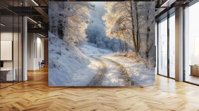 a snow covered road in the middle of a forest Wall mural