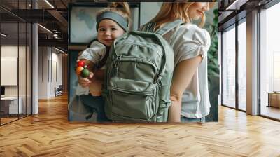 a woman carrying a child in a backpack Wall mural