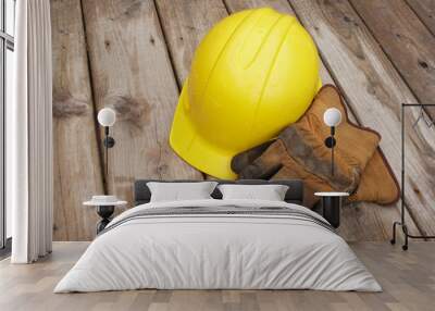 Hard hat and work gloves on wooden deck boards after rainfall. Wall mural