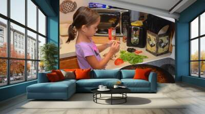 little girl making pizza in kitchen  Wall mural