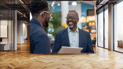 Smiling businessman with digital tablet discussing with male colleague at office, Generative AI Wall mural