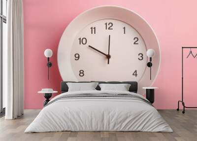 Clock in a white plate on a pink background. Diet and intermittent fasting concept. Dinner time. Wall mural