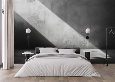 In a dimly lit room, a bright beam of light pierces through, illuminating the textured walls and floor, creating striking contrasts in shades of black and white, background Wall mural