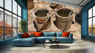 Close up of small wooden barrels filled with water Wall mural