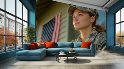 A soldier in uniform standing proudly outside her home, looking off into the distance. Wall mural