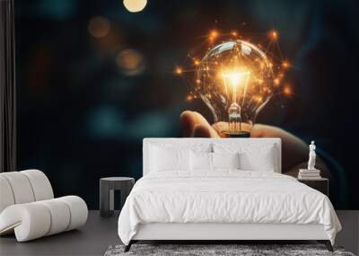 Businessman hand holding creative light bulb with industry network Wall mural