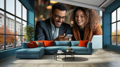 Two business professionals, a man and a woman, are reviewing information on a smartphone Wall mural