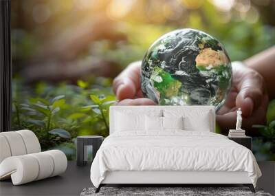 Hands hold a white jigsaw puzzle with a globe inside, symbolizing a friendly world, sustainable environment, and natural preservation. Wall mural