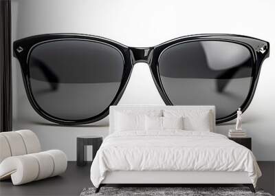 Stylish black sunglasses are isolated on a white background, viewed from the top. Wall mural