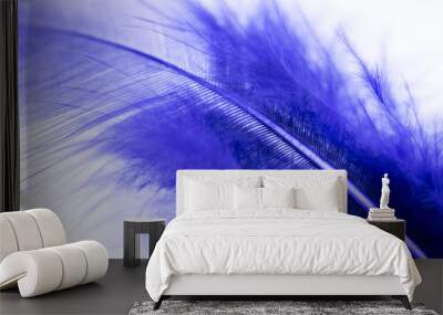 Close up of dark purple feather on a white background (macro concept) Wall mural