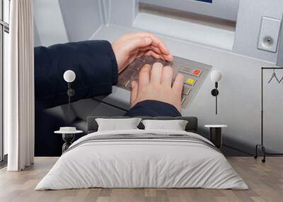 Woman hand writing password for her bank account at ATM (color t Wall mural