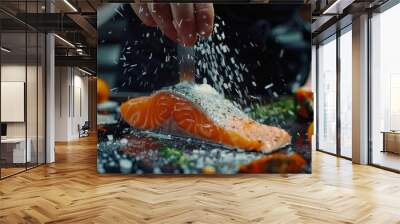 chef prepares salmon steak, process of sprinkling with spices and salt in a freeze motion, marinating salmon fish, adds herbs, seasoning. Long banner format, top view. Wall mural