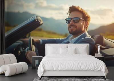 Young successful handsome businessman driving luxury convertible car in the mountains Wall mural