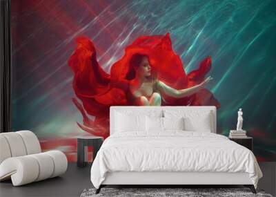 Calm relaxation meditation concept. Sexy fashion model Fantasy woman sitting under water sea, red long silk dress fabric floating. fairy girl posing in deep pool underwater shooting Art Magic light. Wall mural