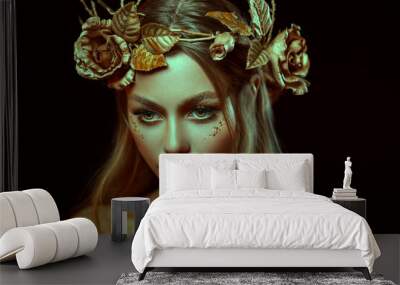 Fantasy portrait of woman with golden skin. Girl goddess in wreath, gold roses, accessories. Beautiful face, steel glitter makeup. Artistic photo, black background. Elf fairy princess. Fashion model. Wall mural