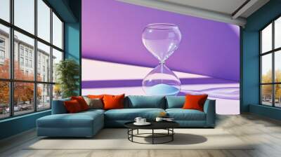 Hourglass with blue sand on a purple background Wall mural