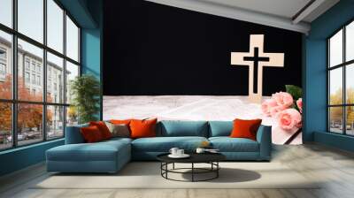 church composition with wooden cross , bible and Beautiful pink flowers on white background, space for text. Wall mural