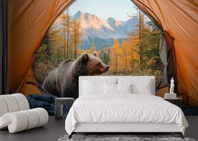 POV from a camping tent: A grizzly bear is looking inside a tent, with a scenic view of the mountains in the autumn
 Wall mural