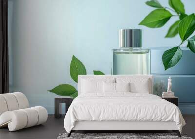 sleek glass perfume bottle and fresh green leaves Wall mural