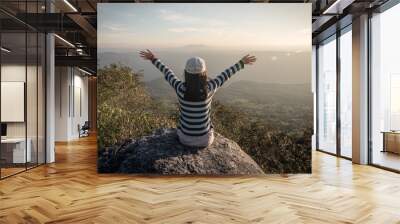 freedom girl with hands up in the mountains Wall mural