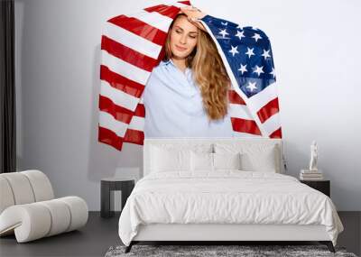 Attractive woman holding an American flag on white background and smile. The concept of migration and of national holidays and Independence Day of Independence of America July 4 Wall mural