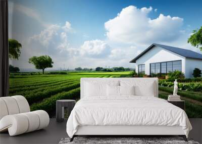 A modern farmhouse sits amidst lush green fields under a bright sky, showcasing agricultural life and rural tranquility. Wall mural