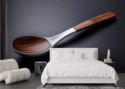 Elegant Wooden Spoon with Metal Handle on Dark Surface Wall mural