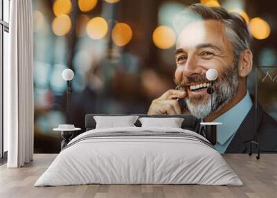 Happy businessman talking on phone, sitting in a modern office environment. Wall mural