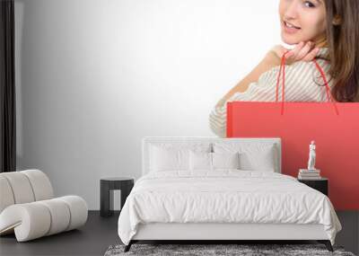 beautiful happy girl shopaholic with red shopping bags, over whi Wall mural