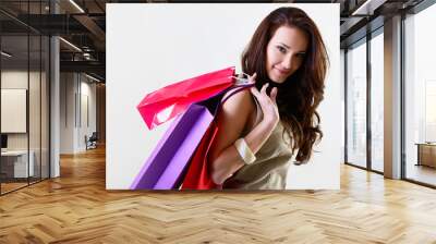 beautiful young woman holding colored shopping bags Wall mural