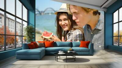 happy young couple eating watermelon on the beach. youth lifesty Wall mural