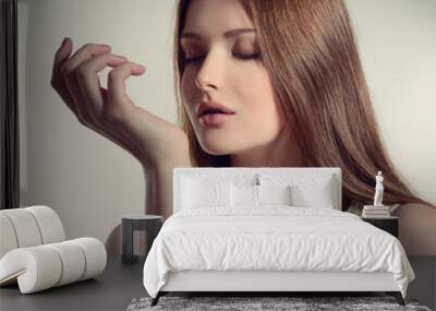 Perfume. Young pretty woman smelling aroma with pleasure, image Wall mural