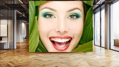 woman beauty face with green leaves frame Wall mural