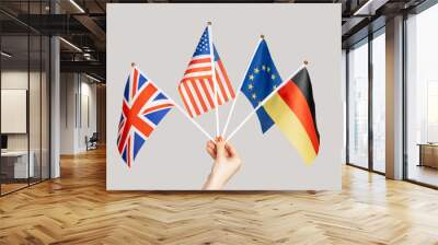 Closeup of woman hand showing Europe, British, american, German flags, countries friendship. Indoor studio shot isolated on gray background. Wall mural