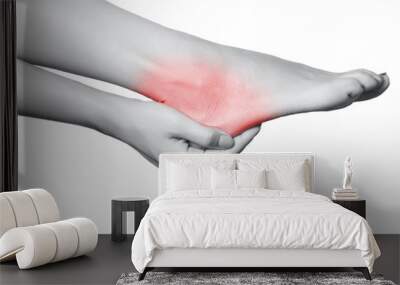 Closeup view of a young woman with pain on leg. isolated on white background. Black and white photo with red dot. Wall mural