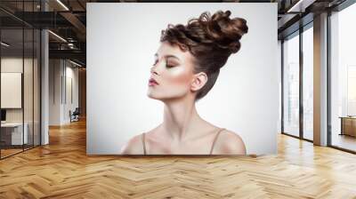 portrait of attractive brunette woman with stylish hairdo and makeup posing with closed eyes on isolated grey background. indoor, studio shot on copy space. Wall mural