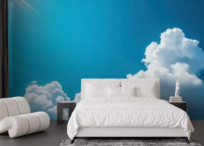 Clear blue sky with a few white clouds, serene weather, bright sunlight Wall mural