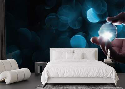 hand holding a glowing digital coin, futuristic concept, copy space on the dark background Wall mural