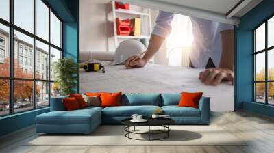 Architect working in office with blueprints,engineer thinking and planning inspection in workplace for architectural plan,sketching a construction project,Business construction concept. Wall mural