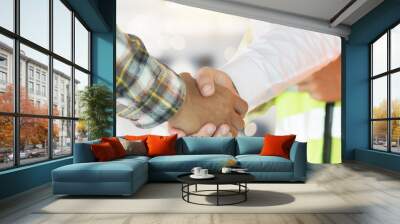 Close up engineer shaking hand with building contractor in construction site , successful negotiate of manager and industrial agreement cooperation concept. Wall mural